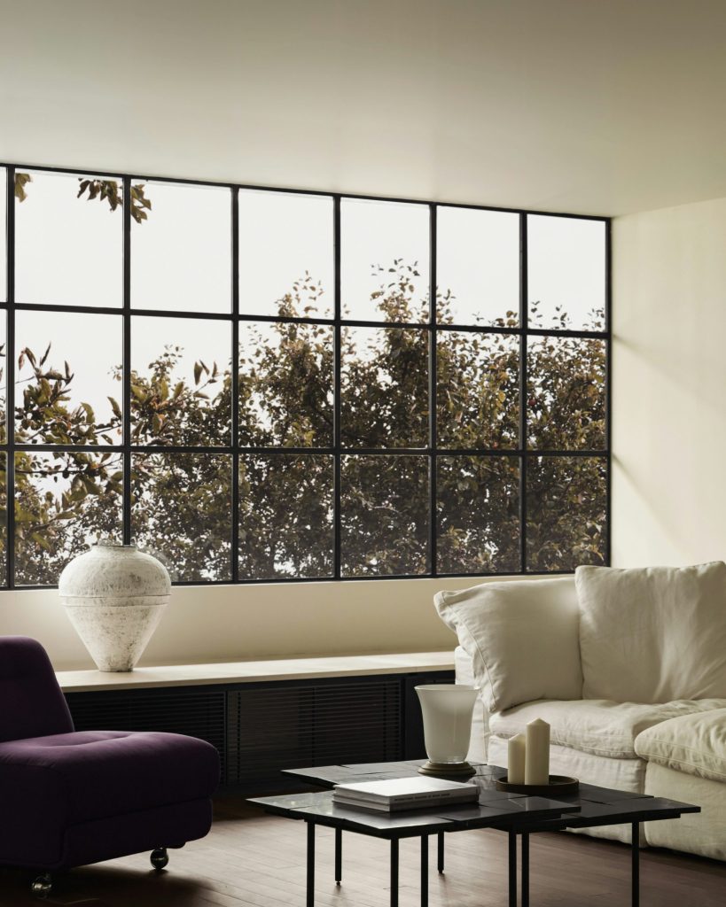 A living room filled with furniture and a large window